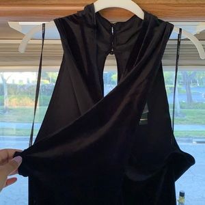 Black velvet romper with crisscross over chest.